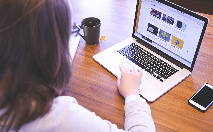 Parent browsing a website on a laptop